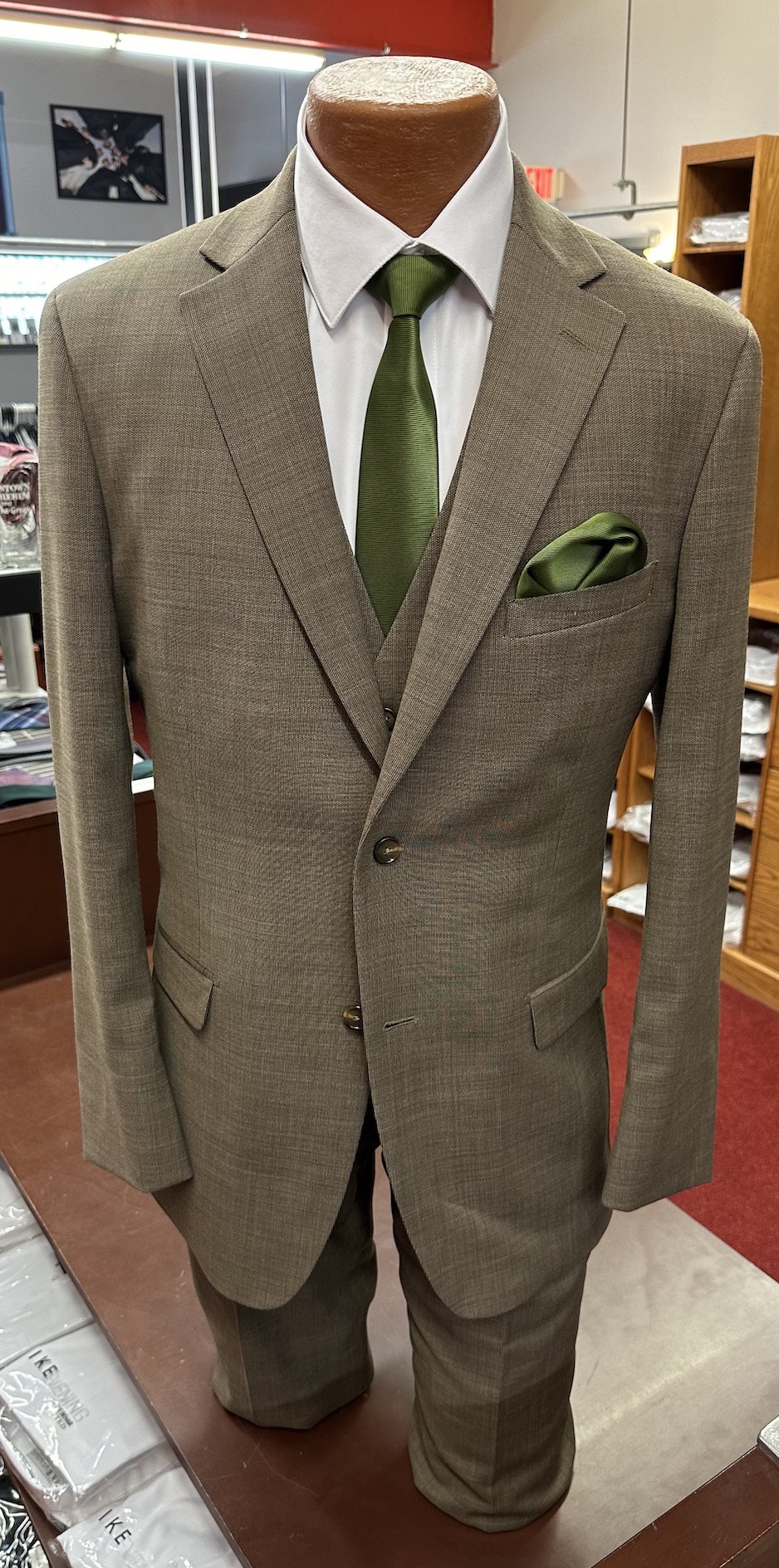 brown suit with green tie and handkerchief